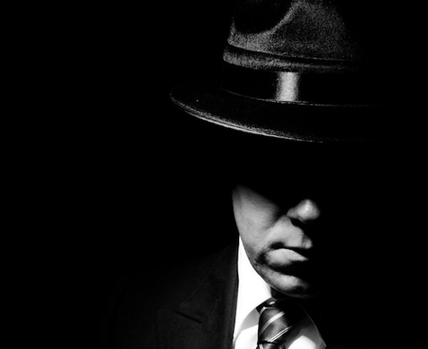 Investigative Report Writing in private investigation represented by shadowy detective